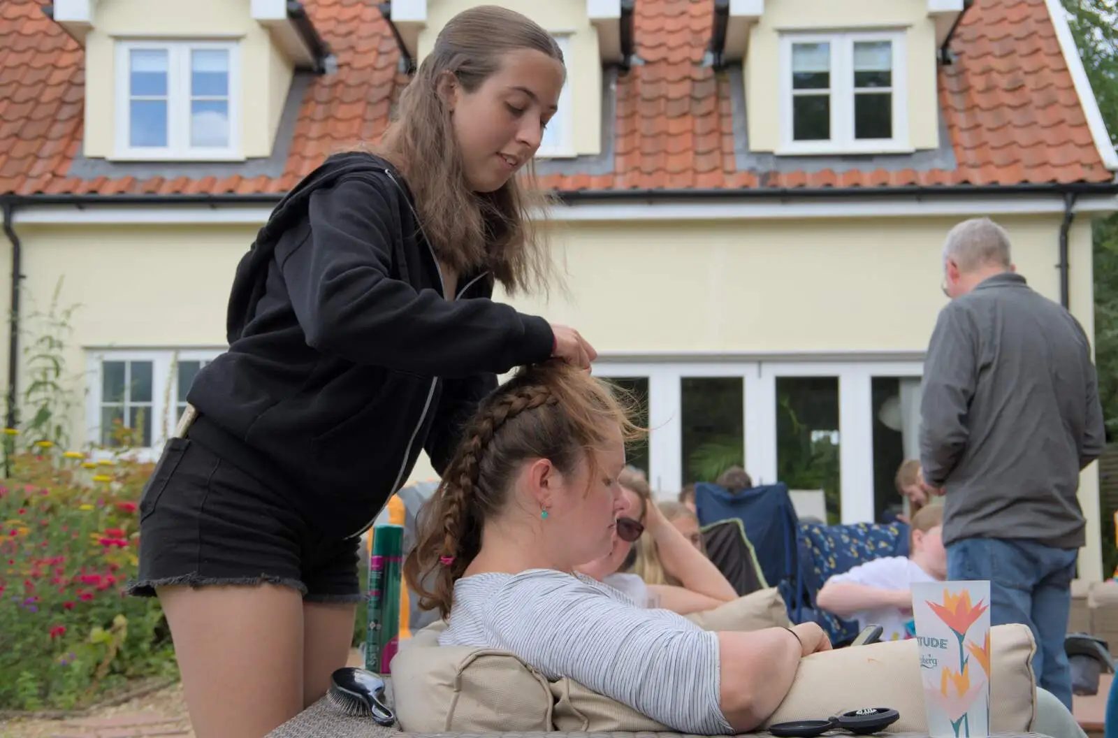 Elsie plaits Isobel's hair, from Lane's End Festival, Bressingham, Norfolk - 14th July 2024