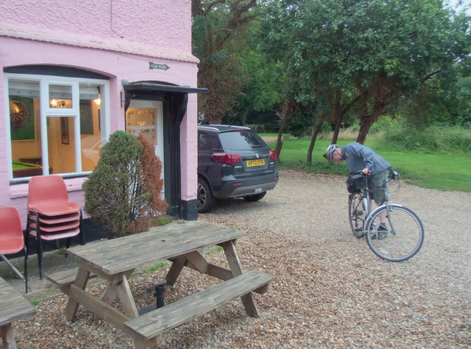 Paul checks his bike outside the pub, from The BSCC at Gissing Crown and Thelnetham White Horse - 18th July 2024