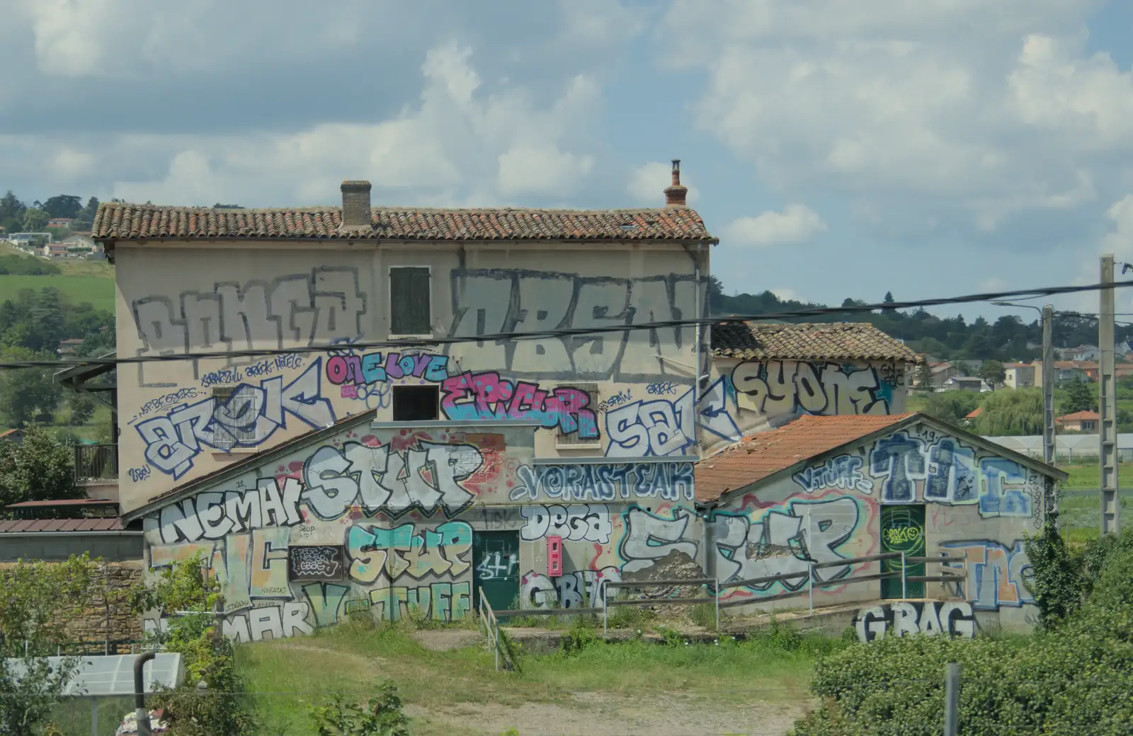 A heavily-graffitoed building, from An Olympic Road Trip from Diss to Marseille, France - 3rd August 2024