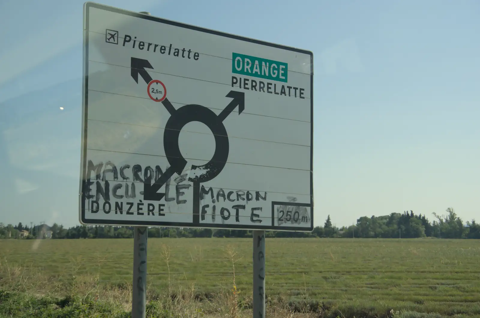 Some anti-Macron graffiti on a road sign, from An Olympic Road Trip from Diss to Marseille, France - 3rd August 2024