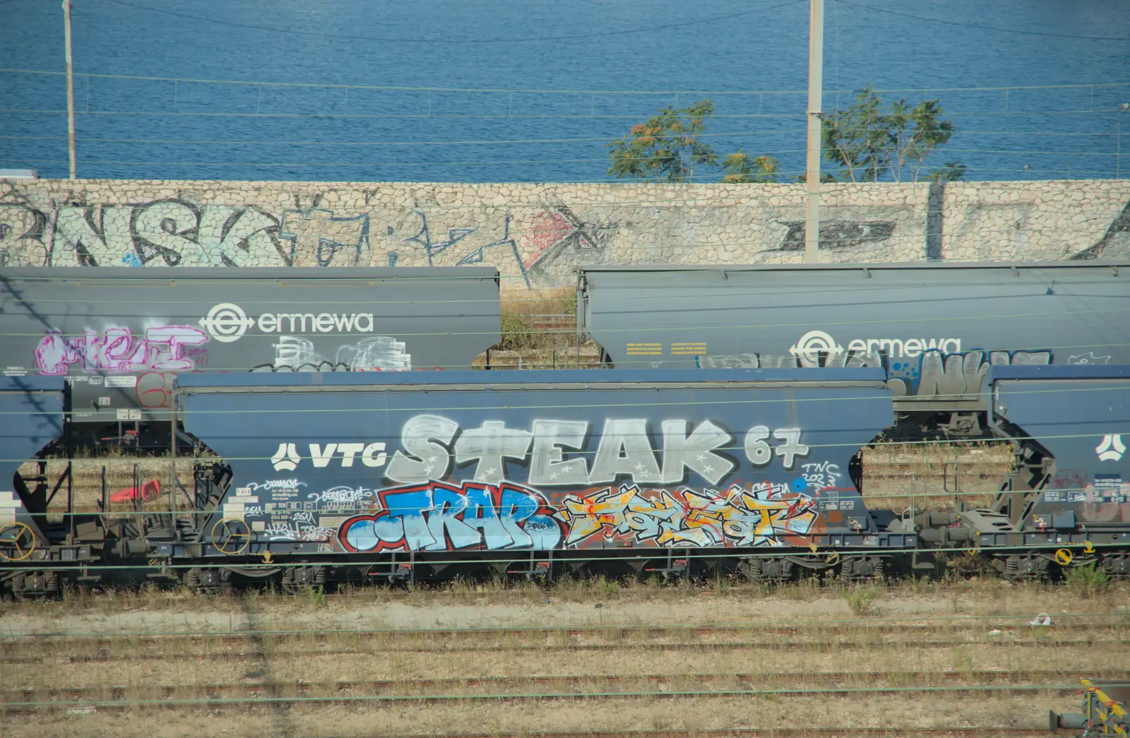 Heavily-graffitoed aggregate rail wagons, from An Olympic Road Trip from Diss to Marseille, France - 3rd August 2024