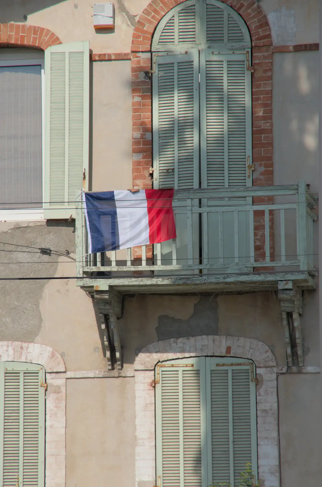 A French tricolour flies from a balcony, from Hannah and Olympic ILCA 6 Sailing, Marseille, France - 5th August 2024