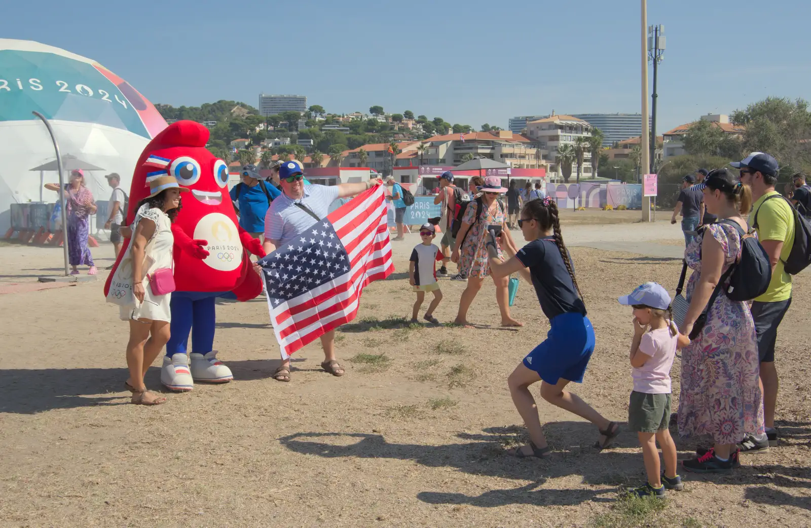 An Olympic mascot does a photo with some USA fans, from Hannah and Olympic ILCA 6 Sailing, Marseille, France - 5th August 2024