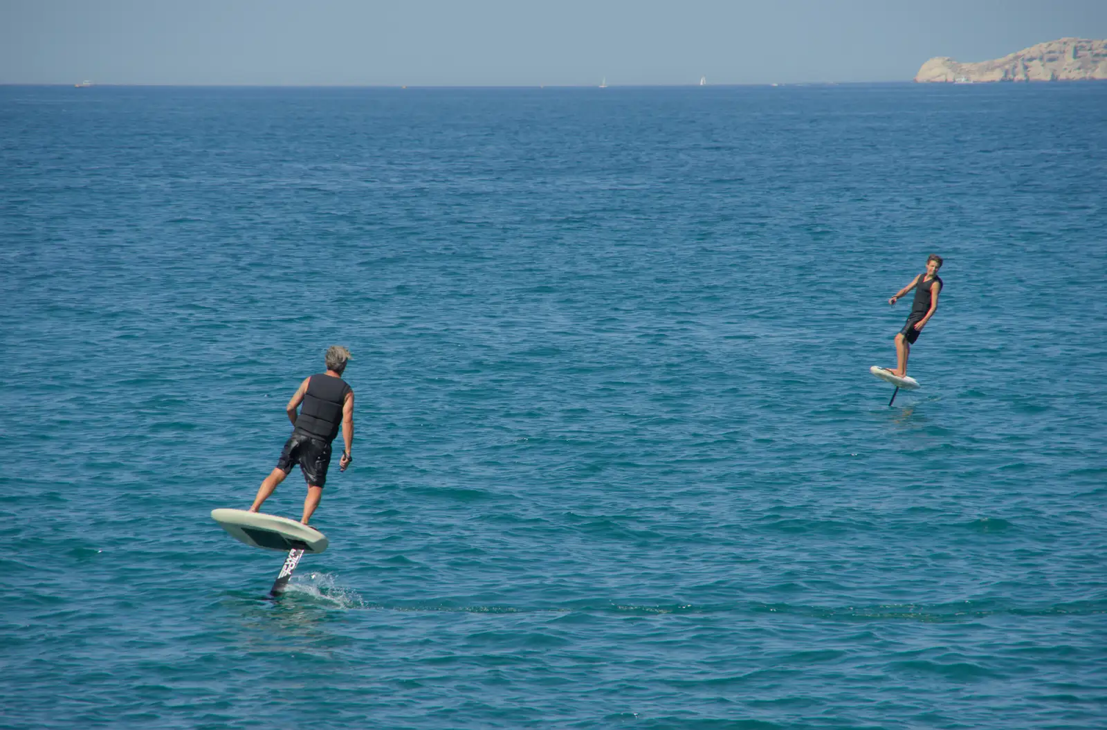 A couple of dudes whizz around on foiling boards, from Hannah and Olympic ILCA 6 Sailing, Marseille, France - 5th August 2024