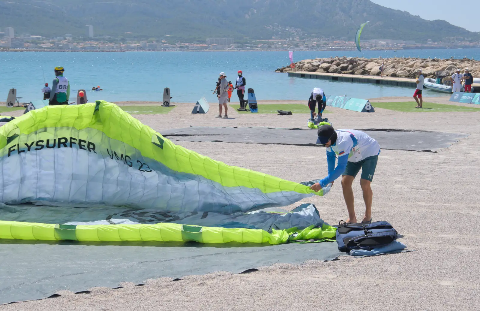 A surfer packs away the kite, from Hannah and Olympic ILCA 6 Sailing, Marseille, France - 5th August 2024