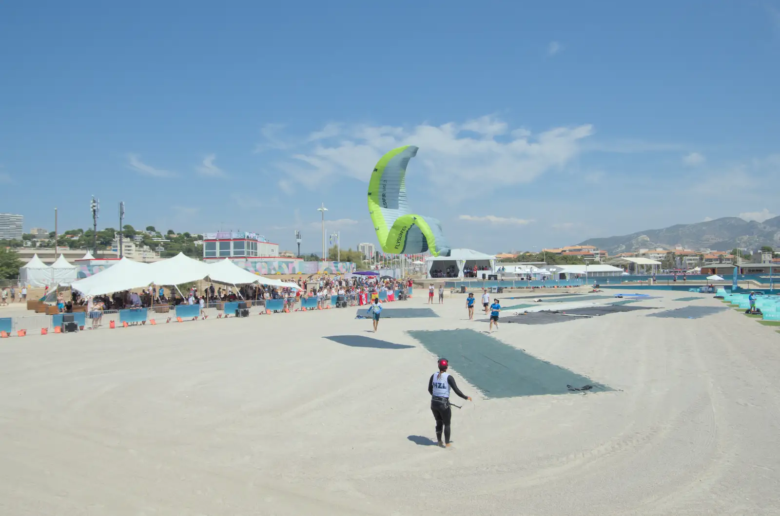 A kite is wrangled in the arena, from Hannah and Olympic ILCA 6 Sailing, Marseille, France - 5th August 2024