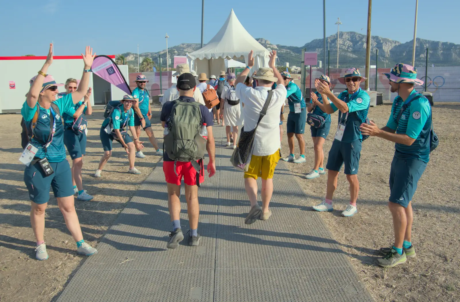 Hamish runs the gauntlet of volunteers, from Hannah and Olympic ILCA 6 Sailing, Marseille, France - 5th August 2024