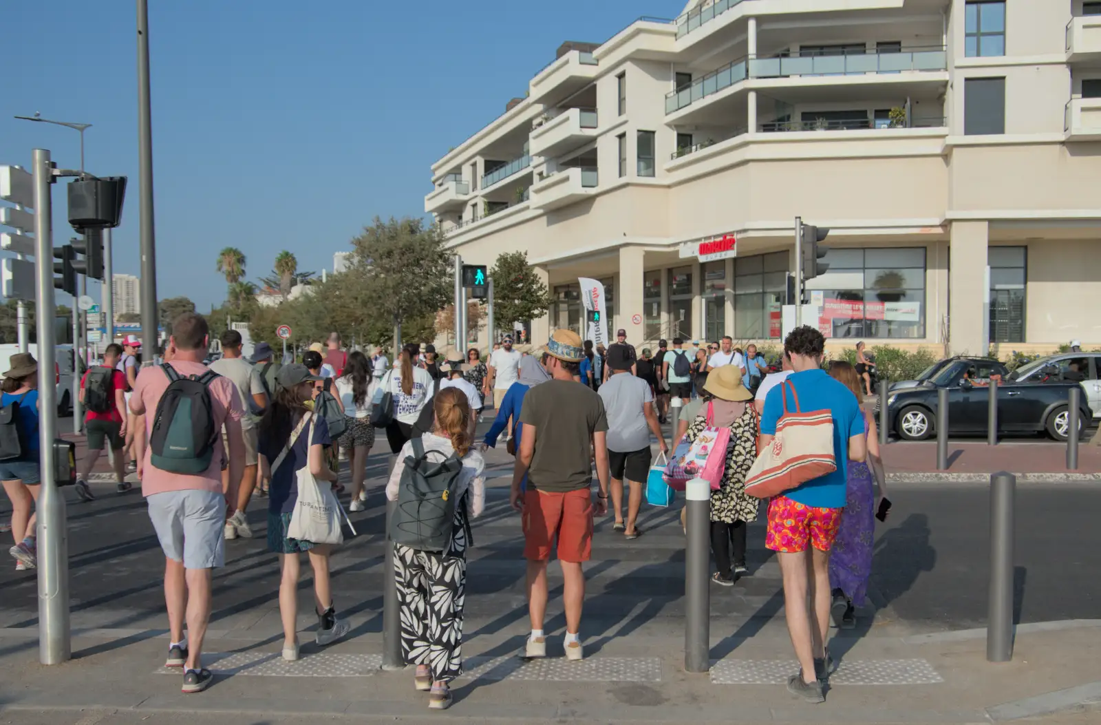 Crowds cross the road near the InterMarché, from Olympic Non-Sailing, Notre Dame, and the Journey Home, Marseille, France - 8th August 2024