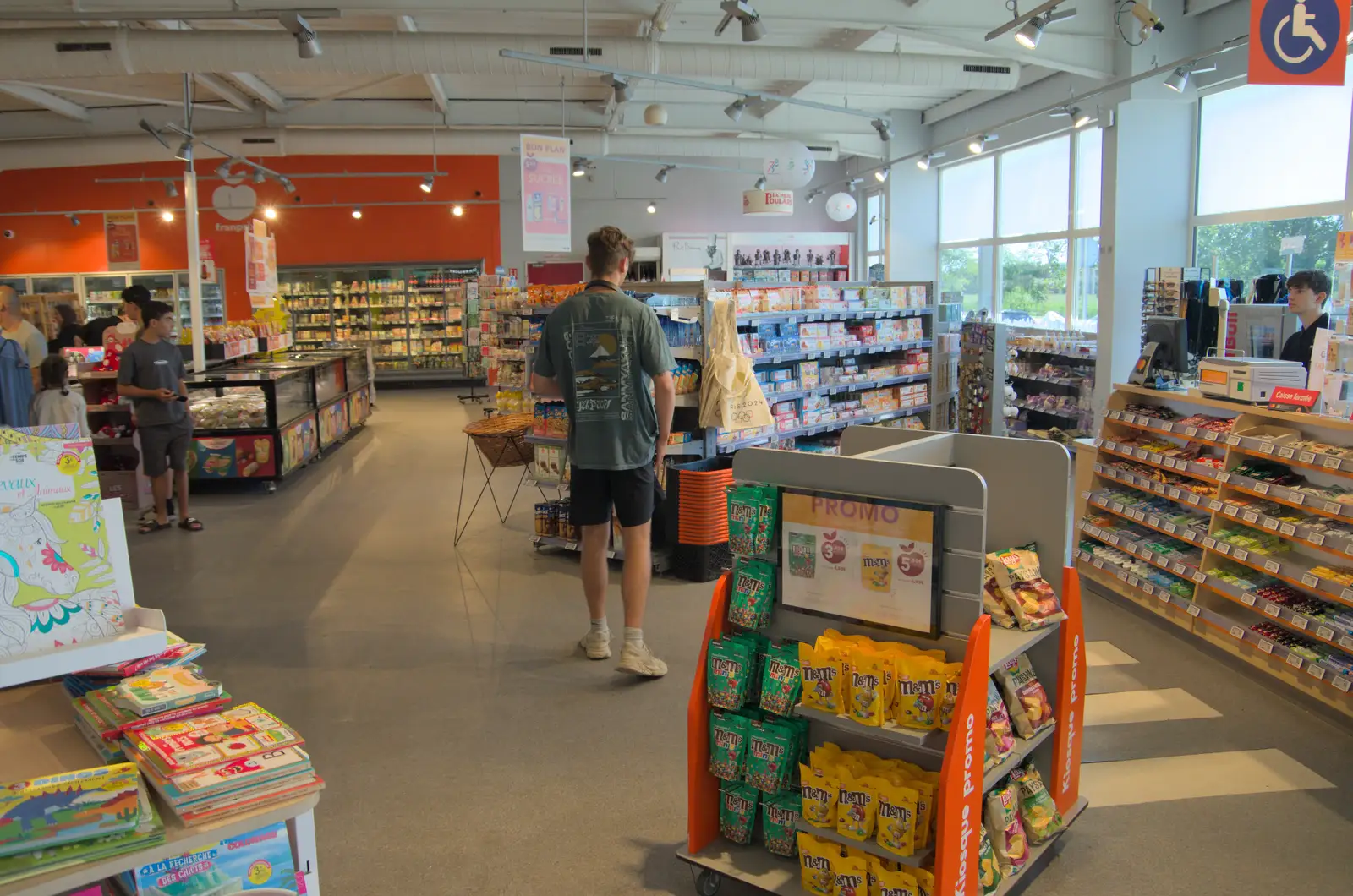 Rowan looks for stuff in the service station shop, from Olympic Non-Sailing, Notre Dame, and the Journey Home, Marseille, France - 8th August 2024