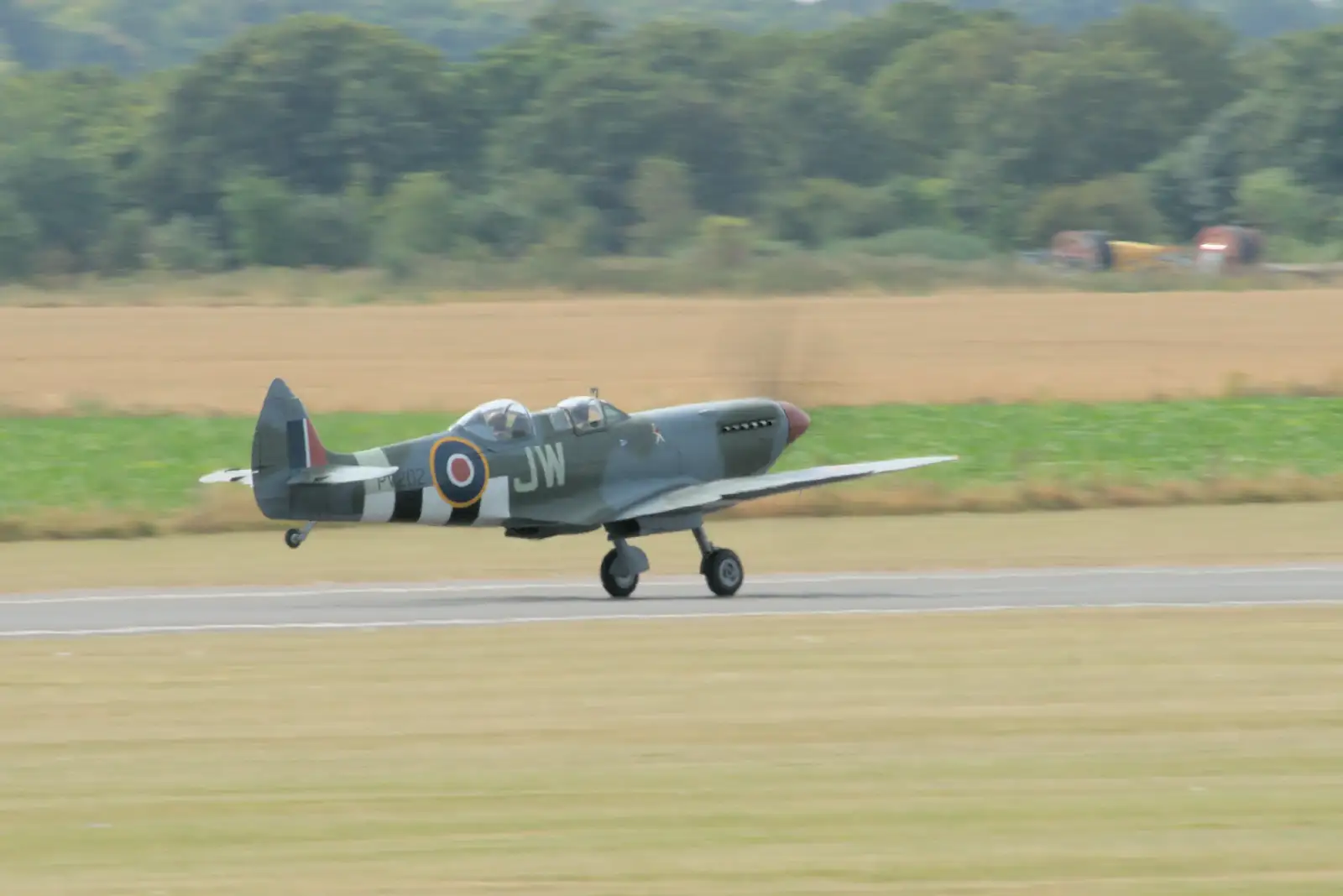 The two-seater Spitfire heads off on a sortie, from Flying in a Dragon Rapide, IWM Duxford, Cambridgeshire - 17th August 2024