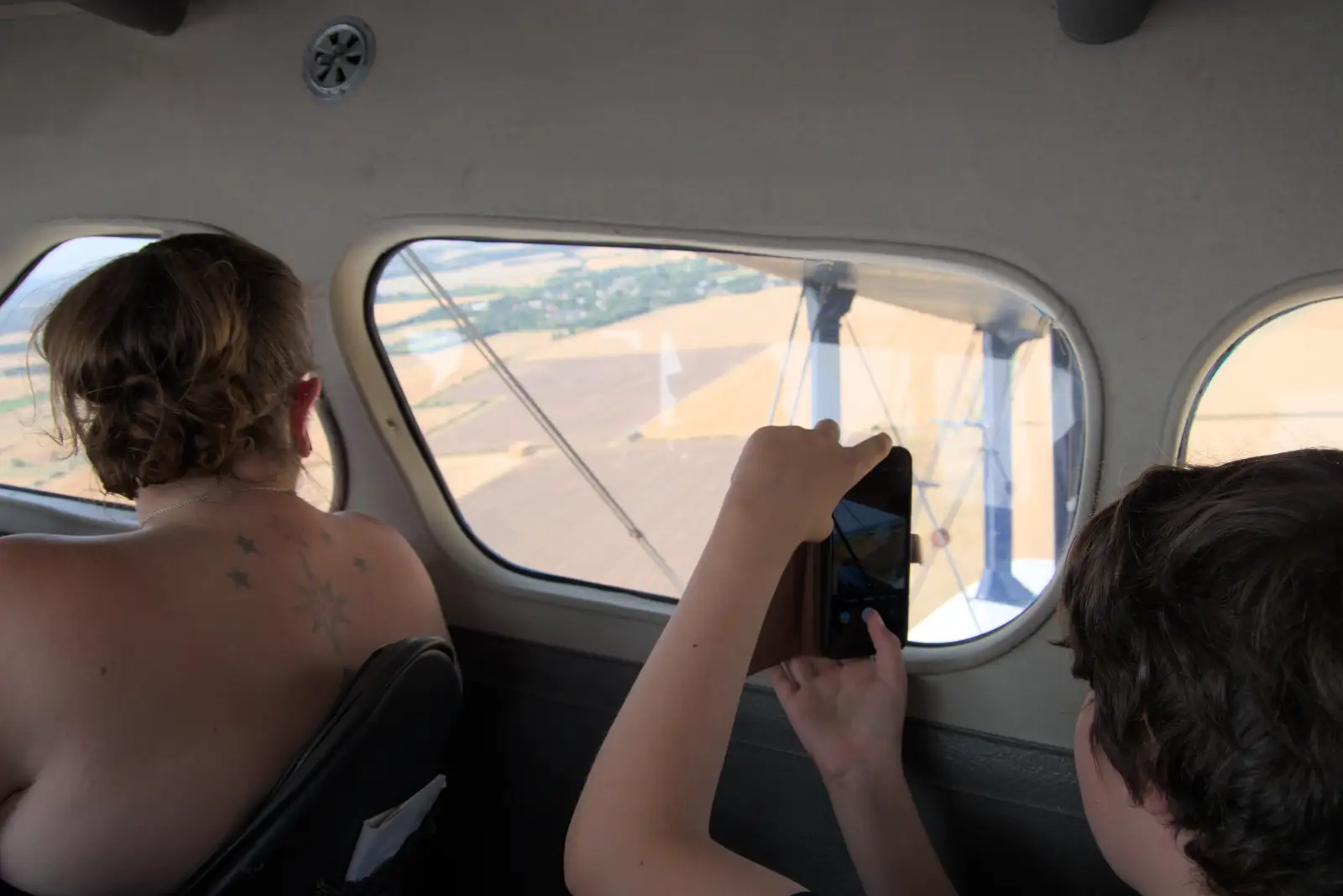 Fred takes photos out of the window, from Flying in a Dragon Rapide, IWM Duxford, Cambridgeshire - 17th August 2024