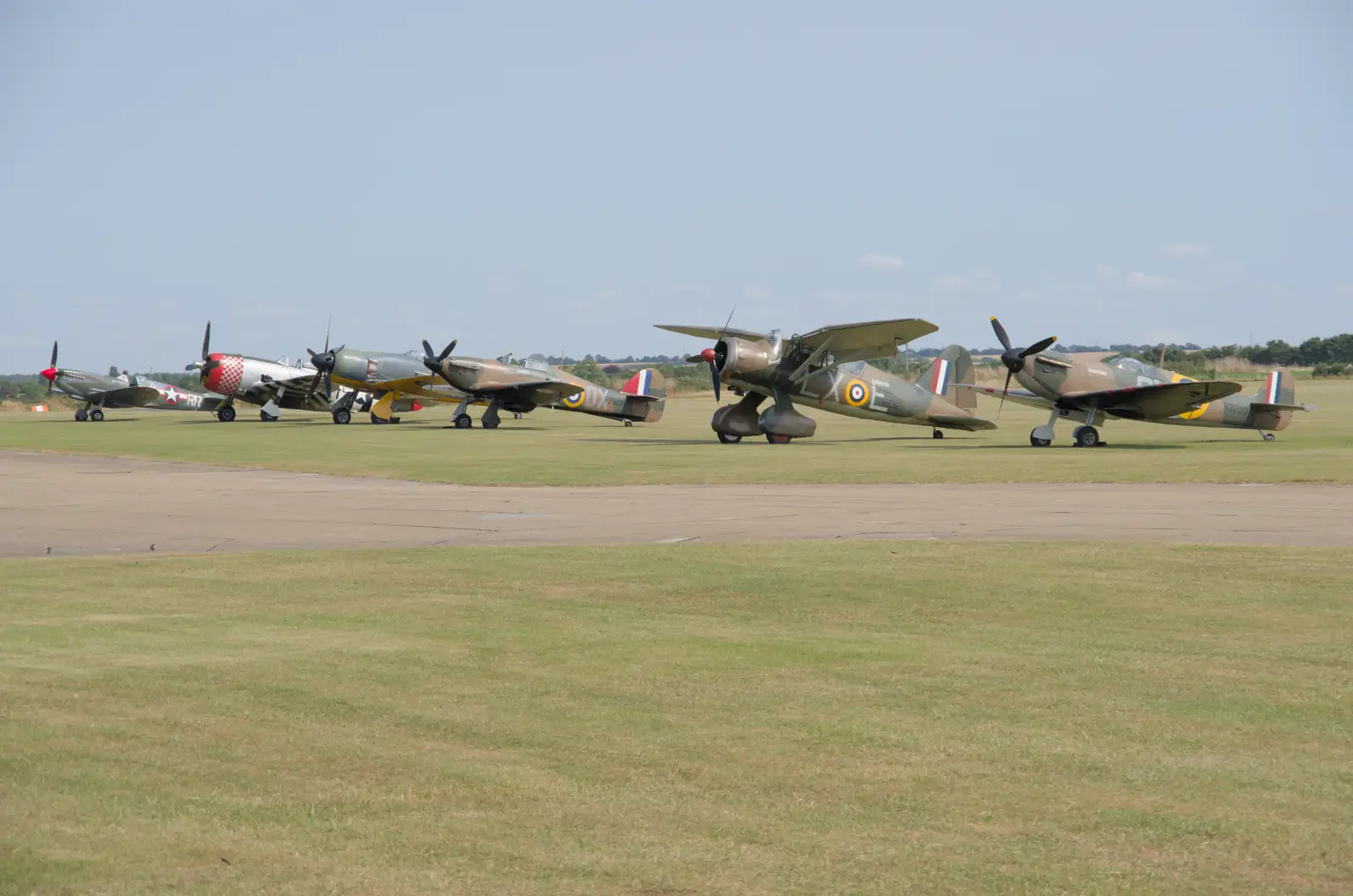 There's a nice lineup of warbirds on the grass, from Flying in a Dragon Rapide, IWM Duxford, Cambridgeshire - 17th August 2024