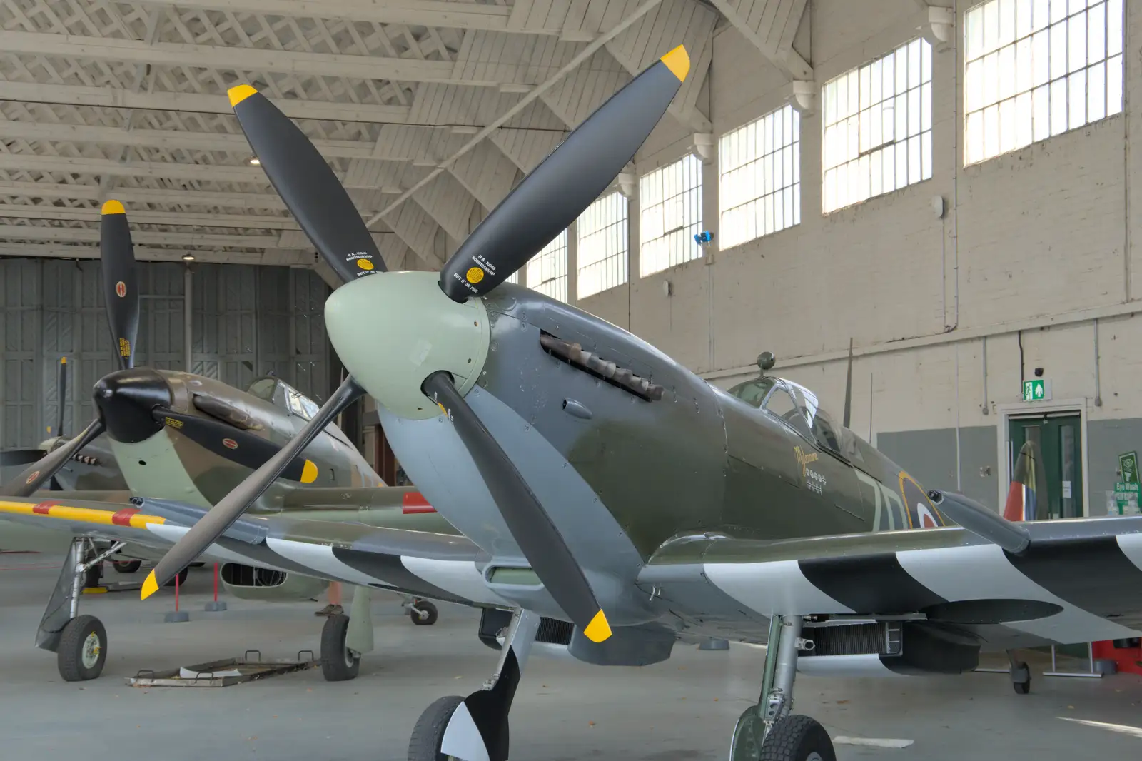 More Spitfires in an original WWII hangar, from Flying in a Dragon Rapide, IWM Duxford, Cambridgeshire - 17th August 2024