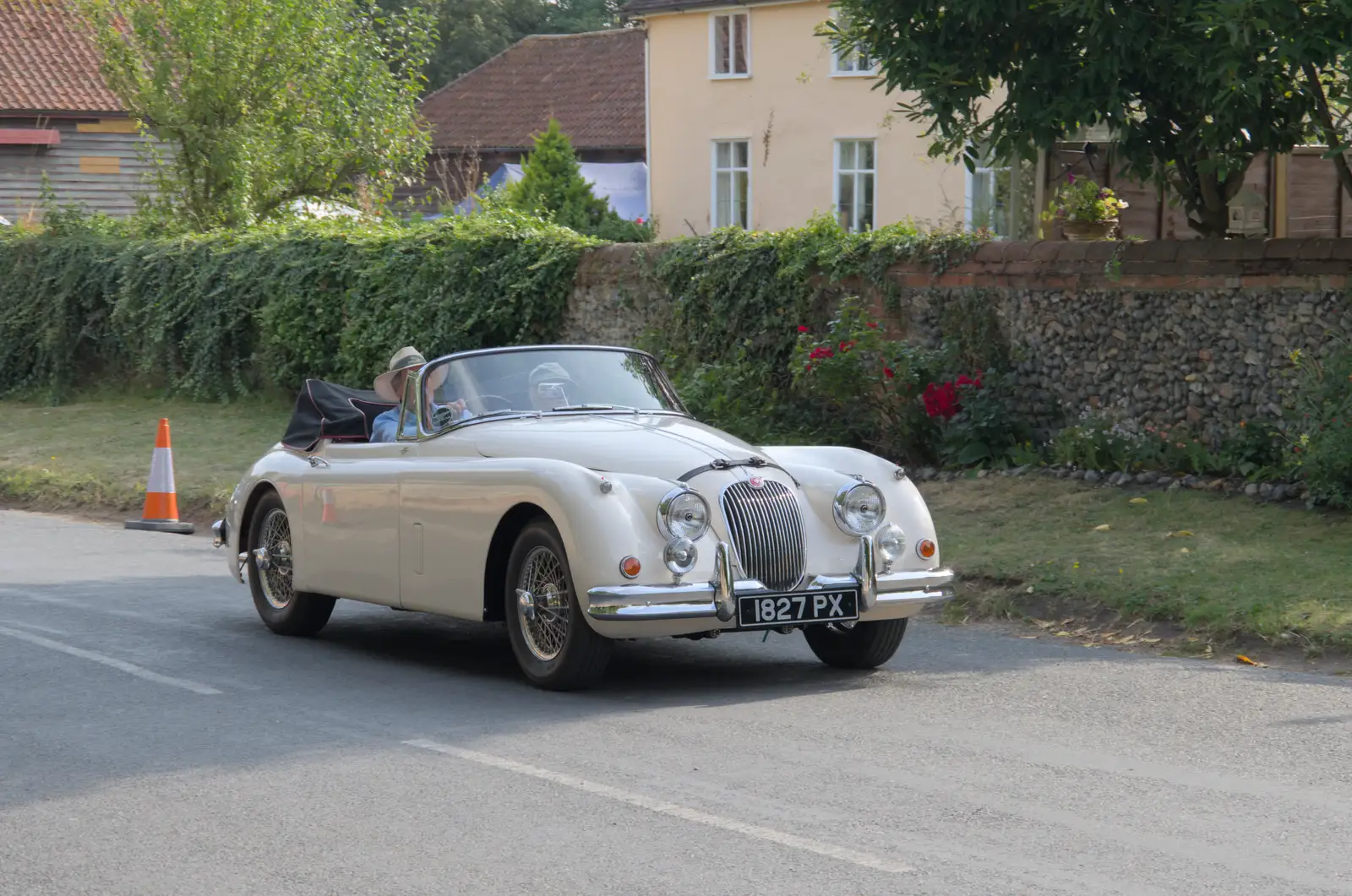 A lovely old Jaguar trundles up the street, from A Summer Party, and the GSB at Walsham le Willows, Suffolk - 26th August 2024