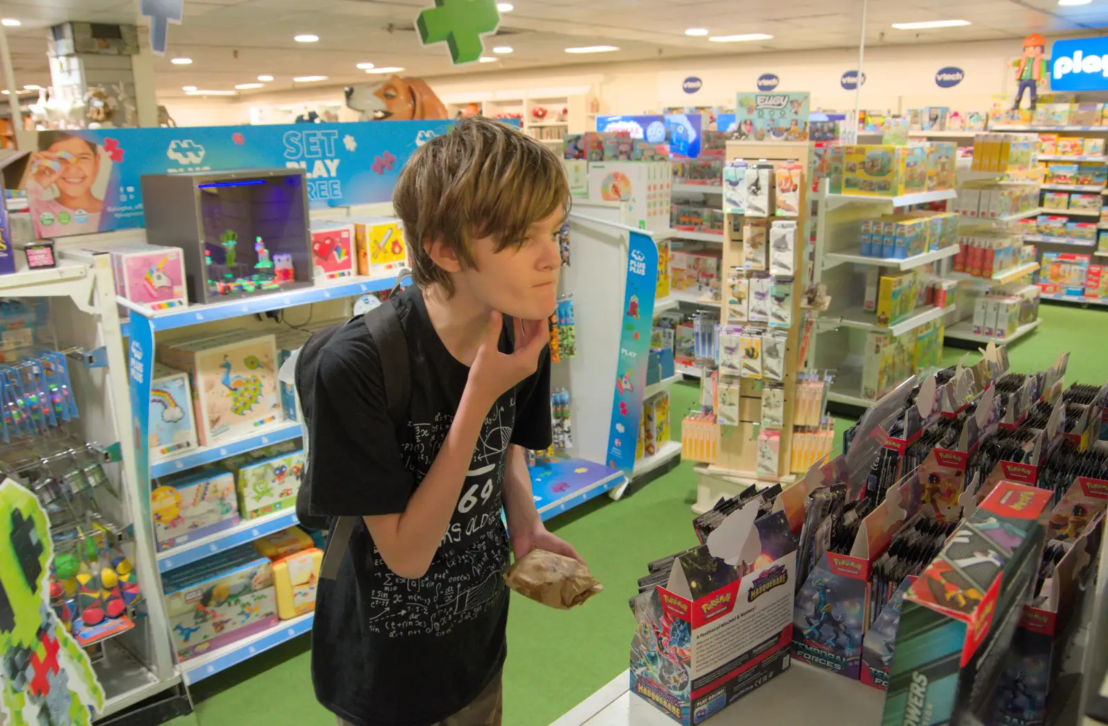 Harry considers some Pokémon cards in Jarrolds, from The Death of the Feather Factory, Diss, Norfolk - 30th August 2024