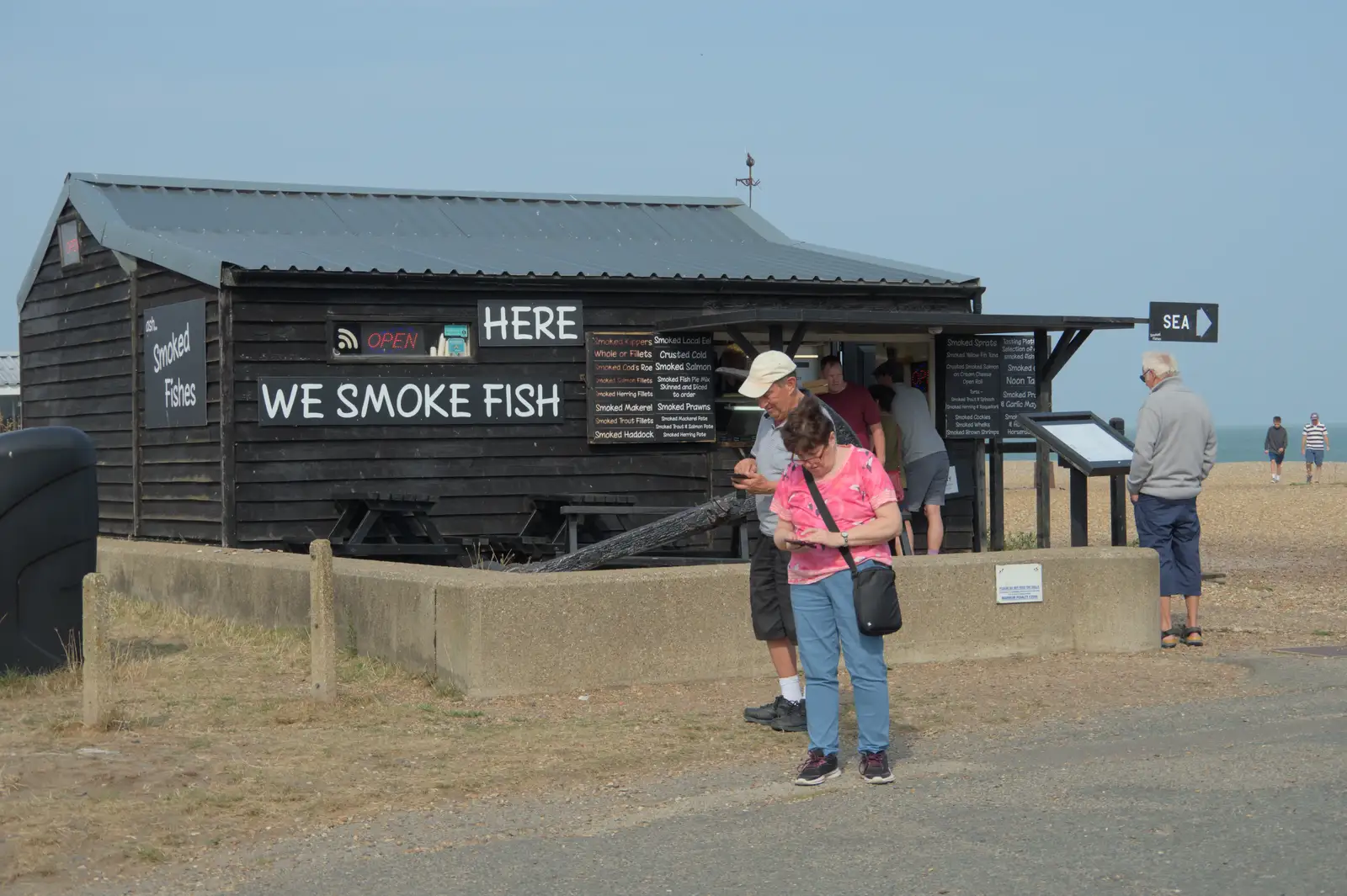 People outside the fish smoking hut, from A Protest on the Beach, Aldeburgh, Suffolk - 1st September 2024