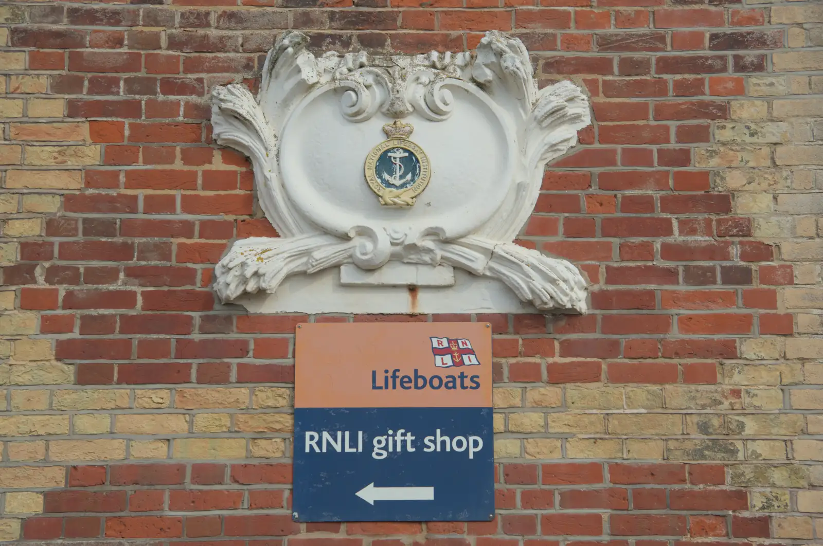 An alabaster RNLI crest on a wall, from A Protest on the Beach, Aldeburgh, Suffolk - 1st September 2024