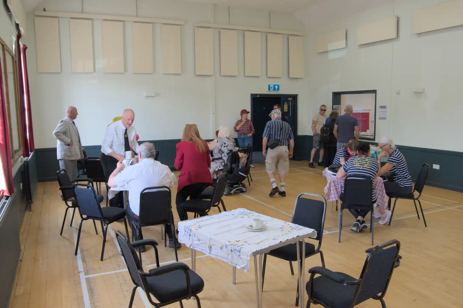 Some of the band hide out in the village hall, from Palgrave Players Busking and the GSB at Pulham Market, Norfolk - 14th September 2024