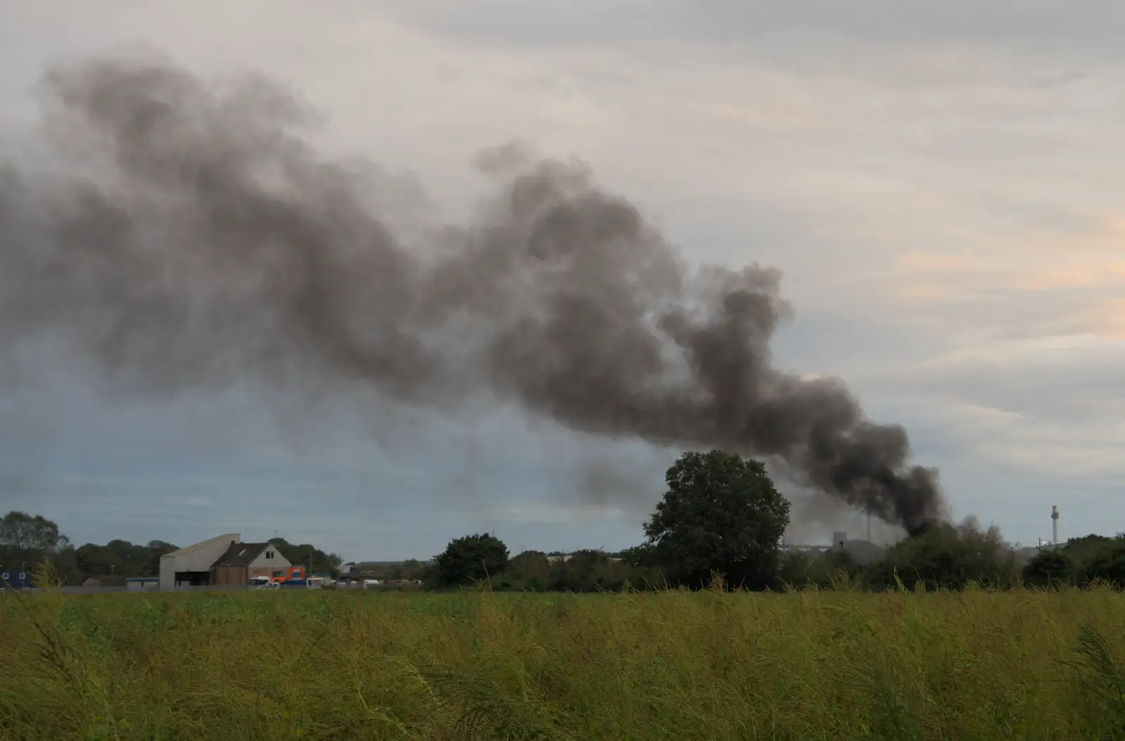 A cloud of smoke drifts over the back field, from A Major Fire at Suffolk Highways, Brome, Suffolk - 15th September 2024