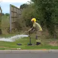 A firefighter taps a fire hydrant, A Major Fire at Suffolk Highways, Brome, Suffolk - 15th September 2024