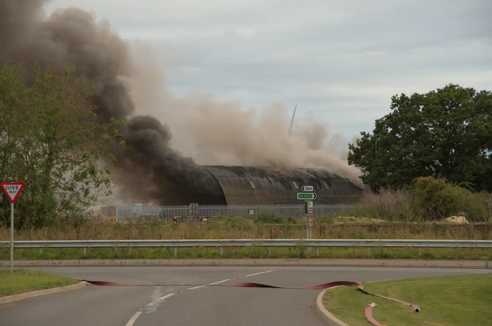 Smoke piles out of the Highways Nissen hut, from A Major Fire at Suffolk Highways, Brome, Suffolk - 15th September 2024