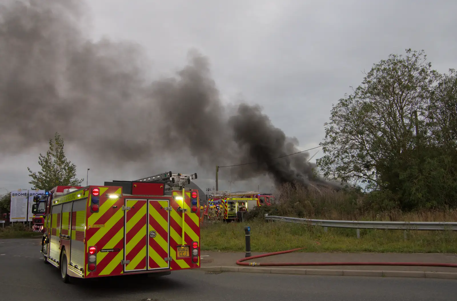 A fire engine partially blocks the road, from A Major Fire at Suffolk Highways, Brome, Suffolk - 15th September 2024