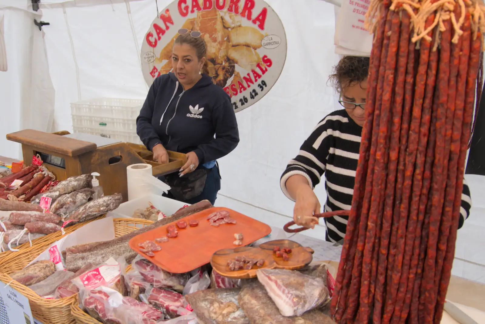 The meat-stick sellers offer some samples, from A Return to Girona, Catalunya, Spain - 29th October 2024