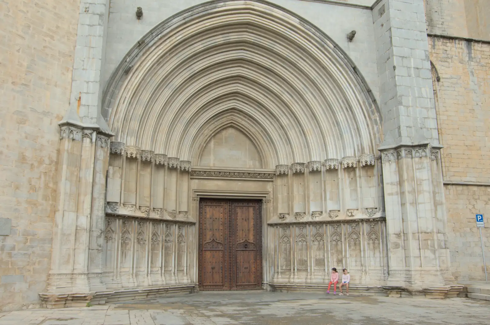 Two children wait outside the cathedral doors, from A Return to Girona, Catalunya, Spain - 29th October 2024