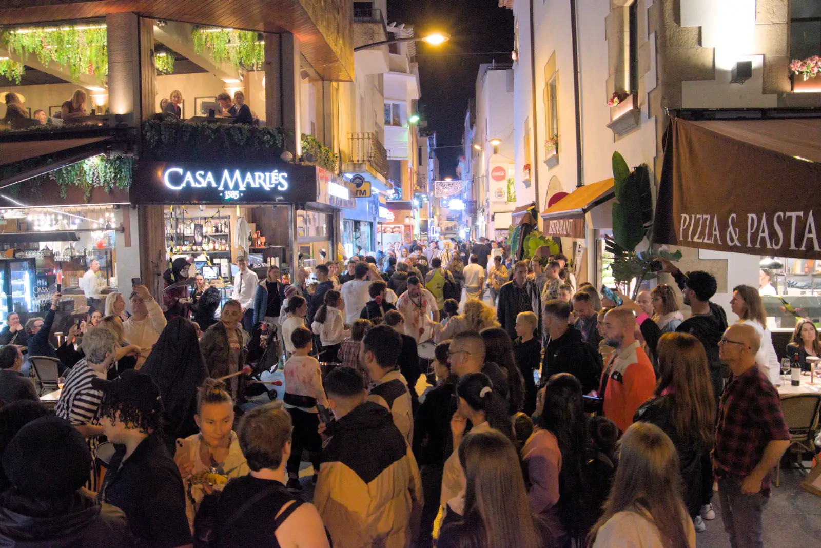 The crowds head off up Calle de San Román, from Halloween and Flamenco Guitar, Lloret de Mar, Catalunya, Spain - 31st October 2024