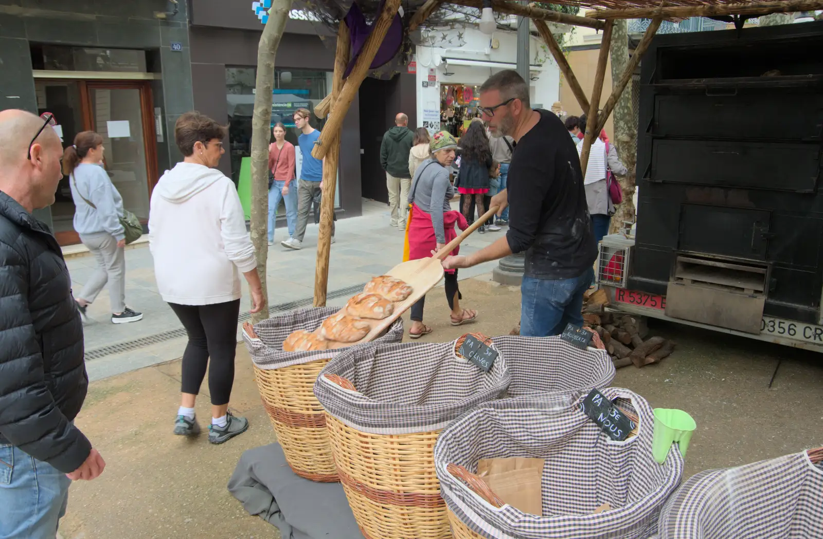 Baked loaves are tipped off a wooden peel, from Blanes, and the Castanyada Festival, Lloret de Mar, Catalunya - 1st November 2024