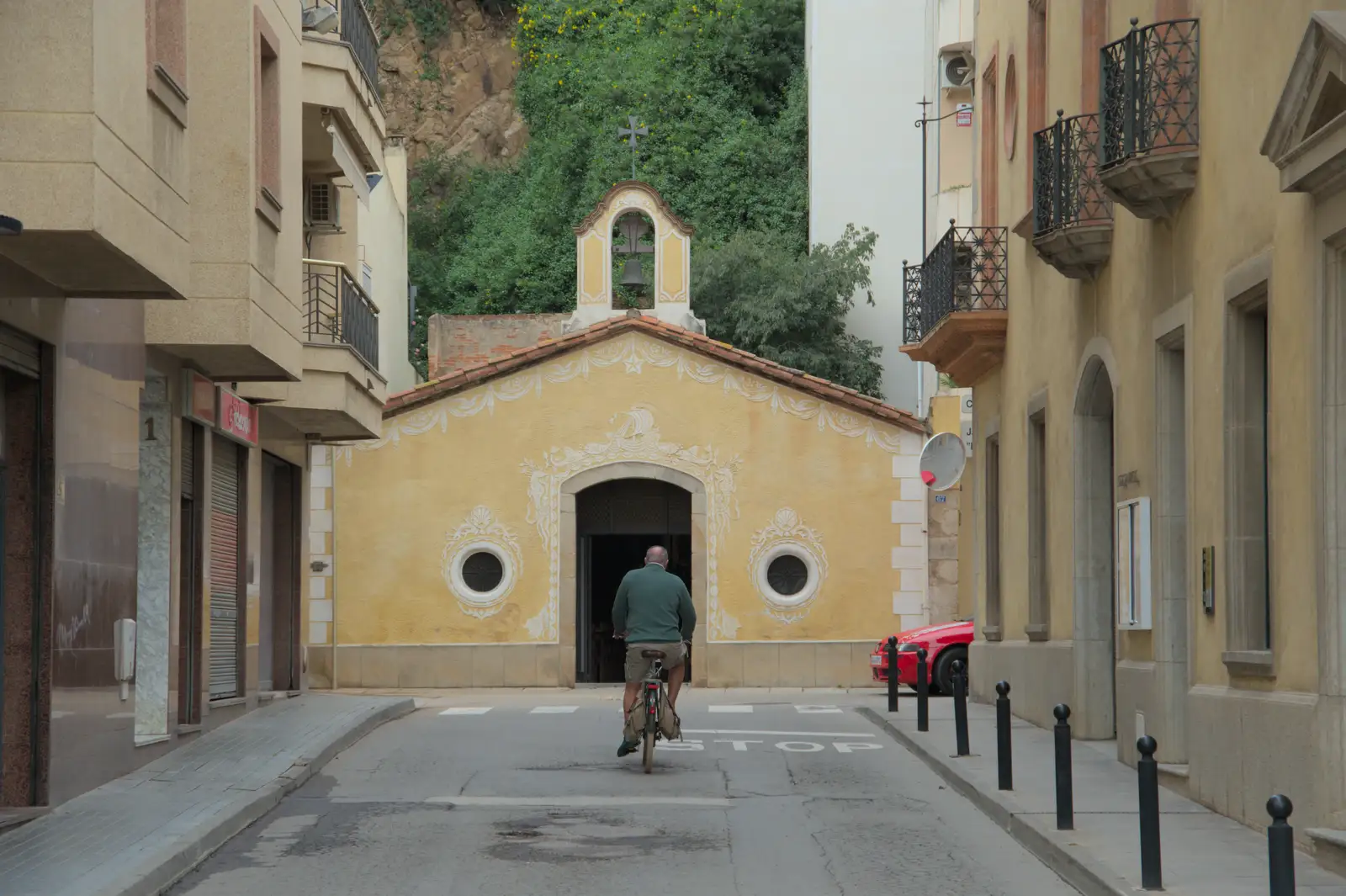 A dude cycles up to an old church, from Blanes, and the Castanyada Festival, Lloret de Mar, Catalunya - 1st November 2024