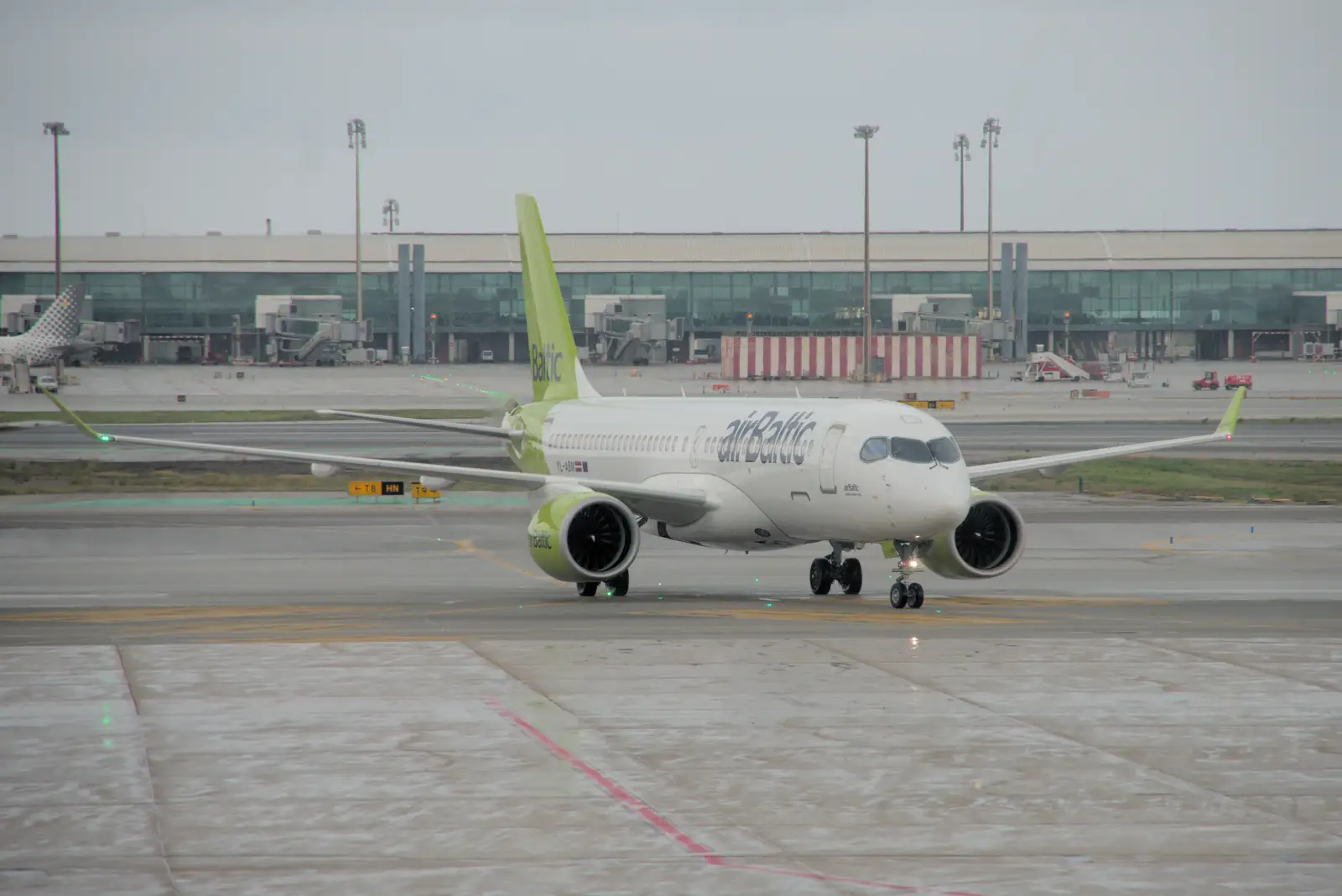 An Air Baltic Airbus A319 taxis by, from Blanes, and the Castanyada Festival, Lloret de Mar, Catalunya - 1st November 2024