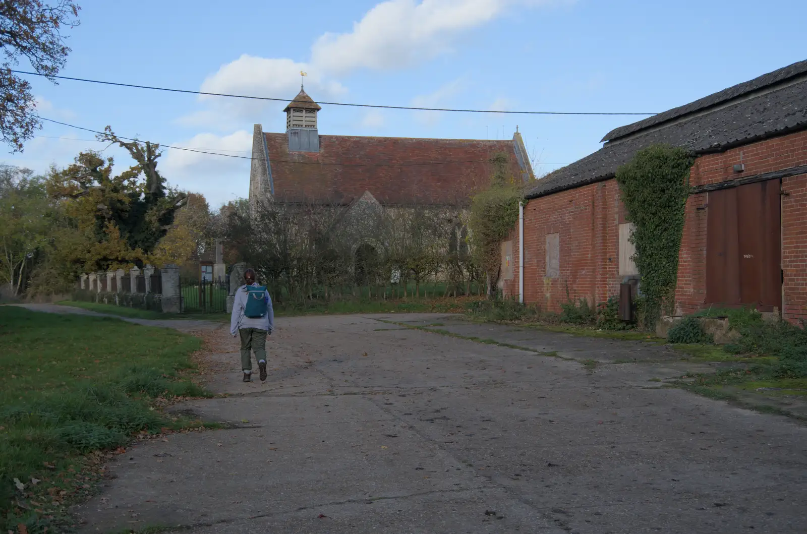 Isobel wanders off to the church, from A Pub Walk to Ampersand, Diss, Norfolk - 17th November 2024