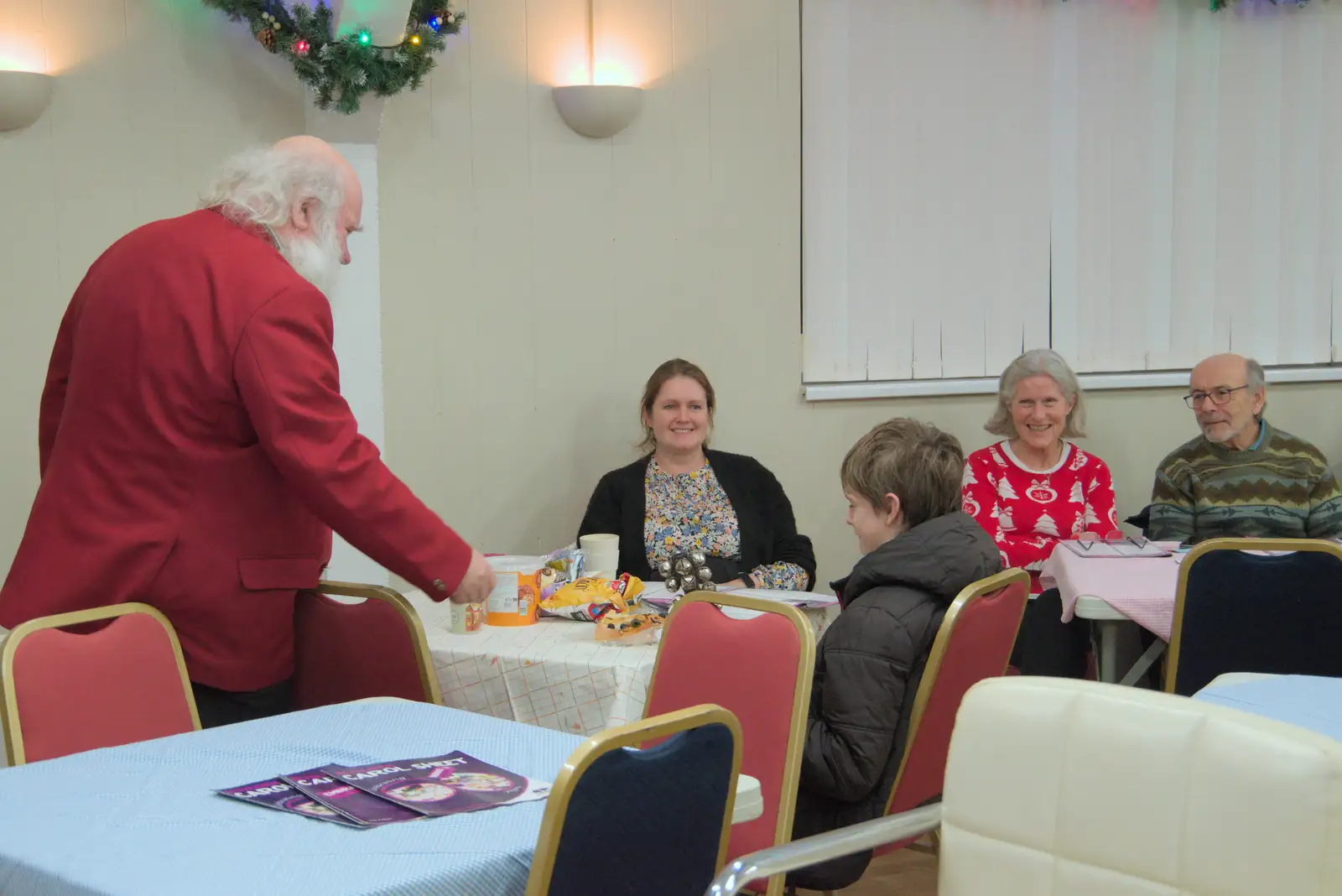 Adrian tries to get Harry on the jingle bells, from A Weekend of Music with the GSB, Gislingham and Thornham - 15th December 2024