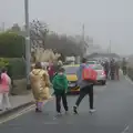 Someone wanders down the road in a gold Dryrobe, St. Stephen's Day in Blackrock, County Dublin, Ireland - 26th December 2024