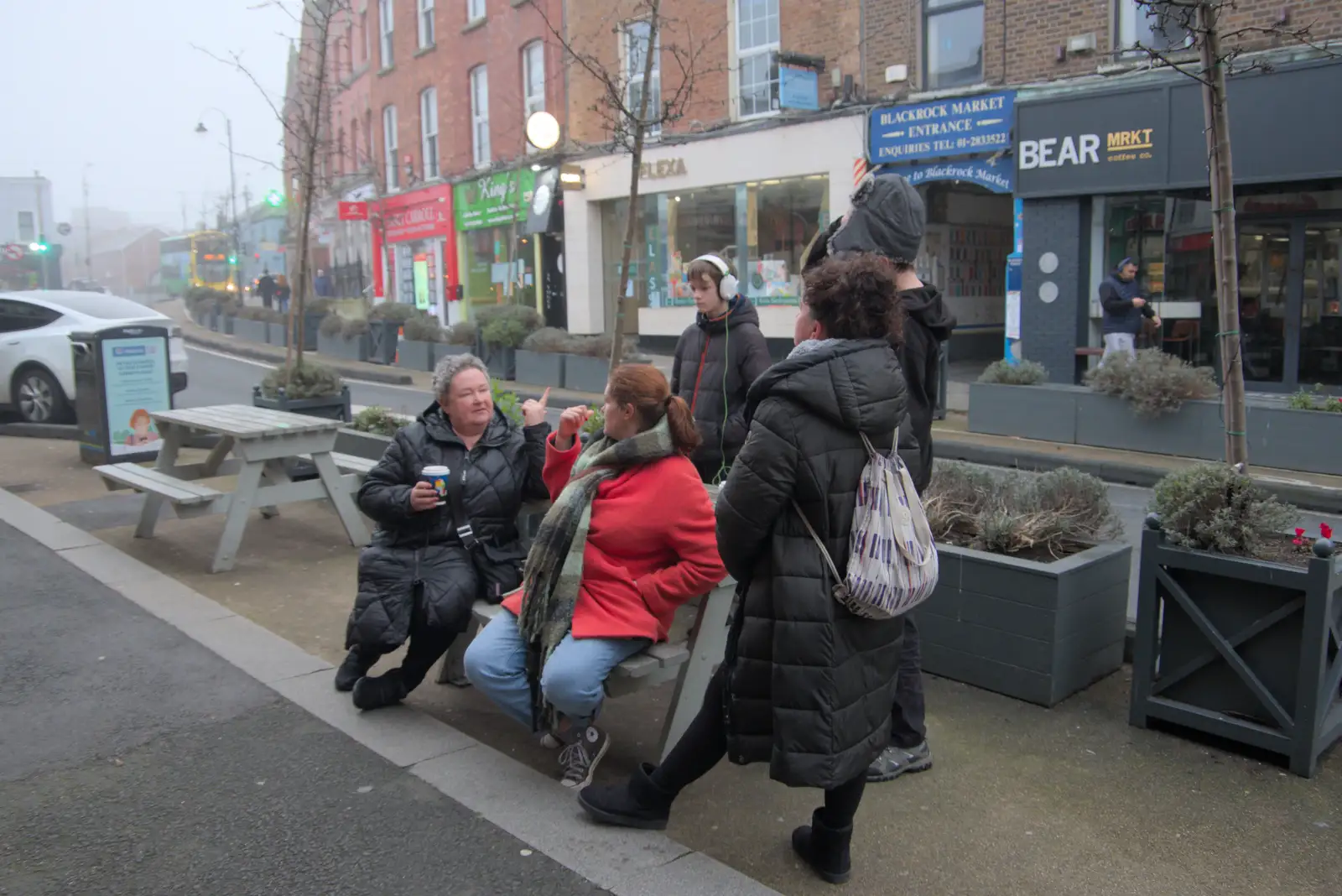 Isobel sits down in Blackrock, from St. Stephen's Day in Blackrock, County Dublin, Ireland - 26th December 2024