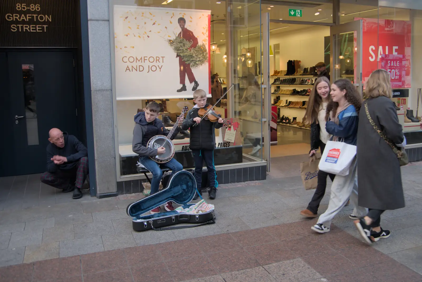 Two young lads play trad on Grafton Street, from St. Stephen's Day in Blackrock, County Dublin, Ireland - 26th December 2024