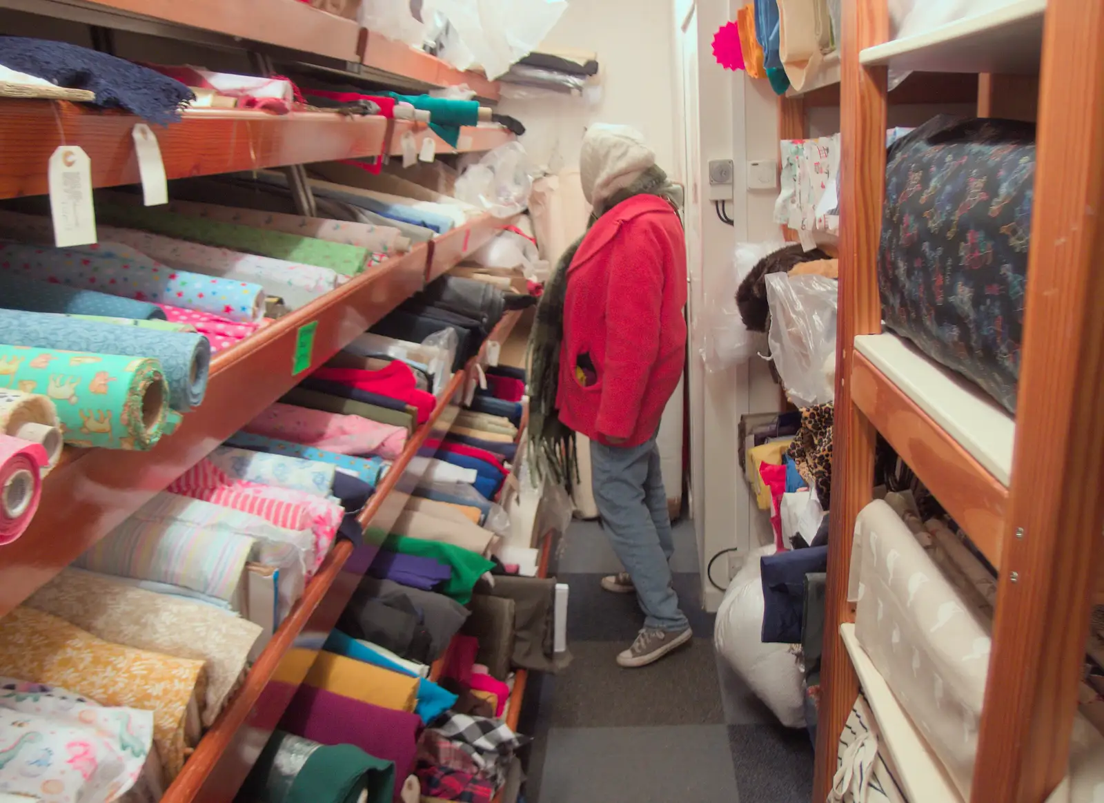 Isobel looks for 'sea' fabric in the Fabric Shop, from Dove Players do Treasure Island, The Village Hall, Occold - 11th January 2025