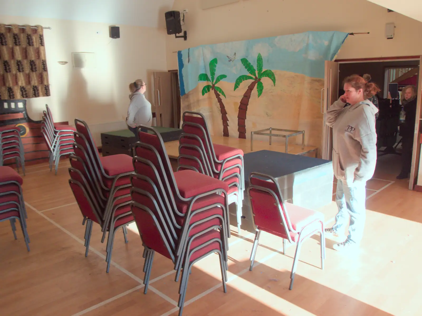 Isobel considers a stack of chairs, from Dove Players do Treasure Island, The Village Hall, Occold - 11th January 2025