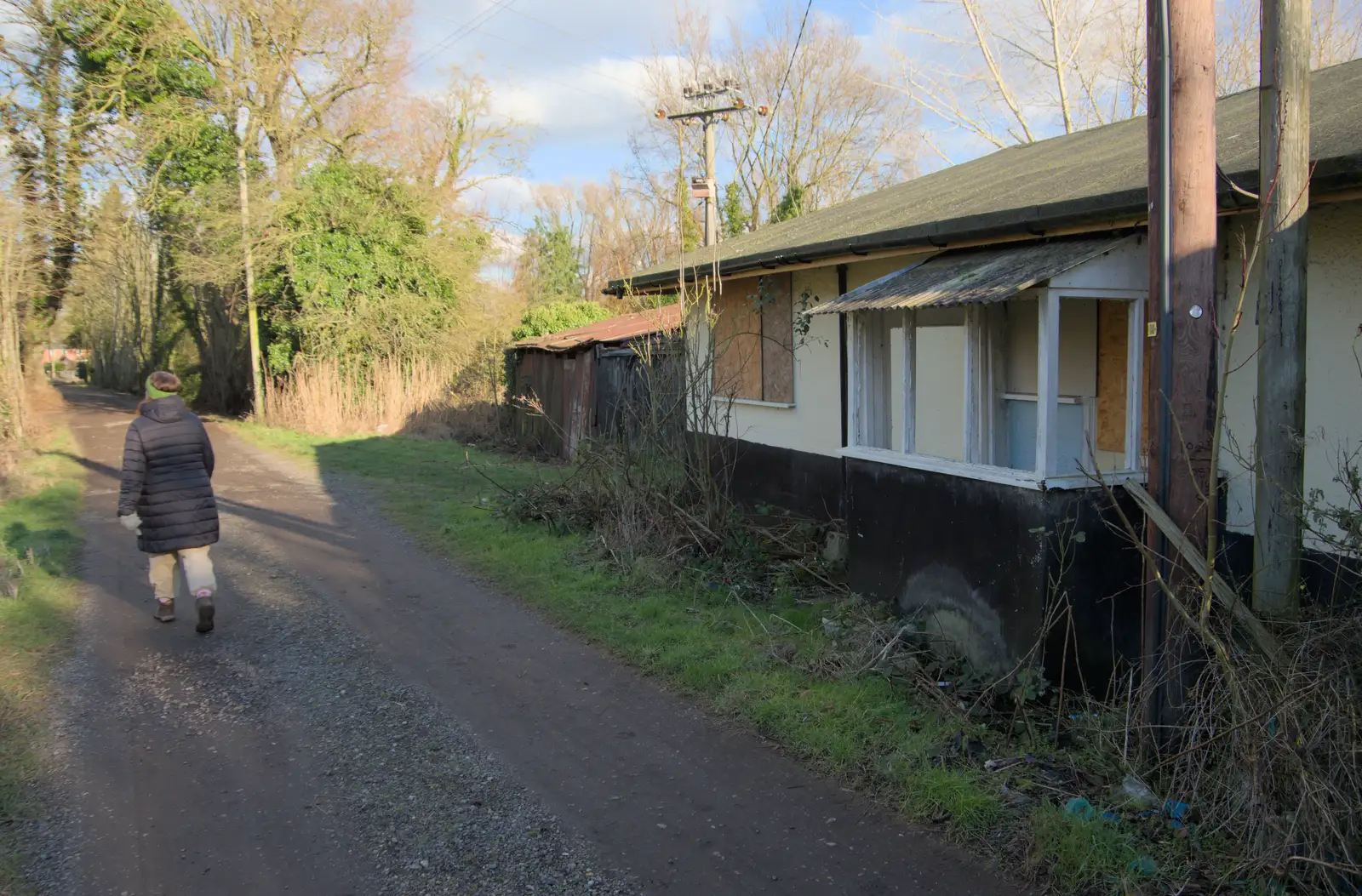 Isobel wanders past a very-derelict bungalow, from The Demolition of Park Road, Diss, Norfolk - 1st February 2025