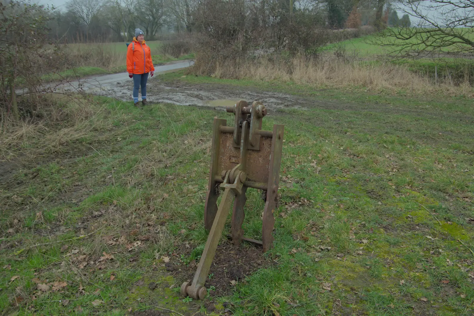 Isobel stands near some random farm ironwork, from A Pub Walk to the Railway Tavern, Mellis, Suffolk - 9th February 2025