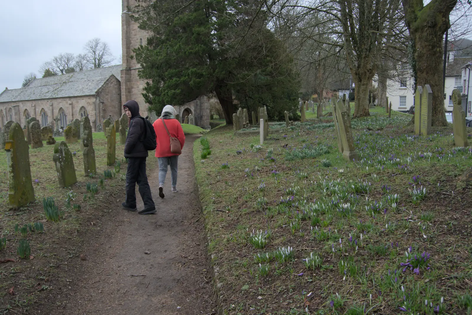 Harry looks back as we walk through the churchyard, from A Return to Chagford, Devon - 16th February 2025