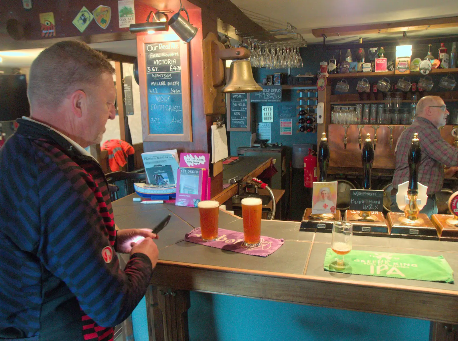 Gaz gets the first round in in the Greyhound, from The BSCC at the Greyhound, Botesdale, Norfolk - 15th May 2025