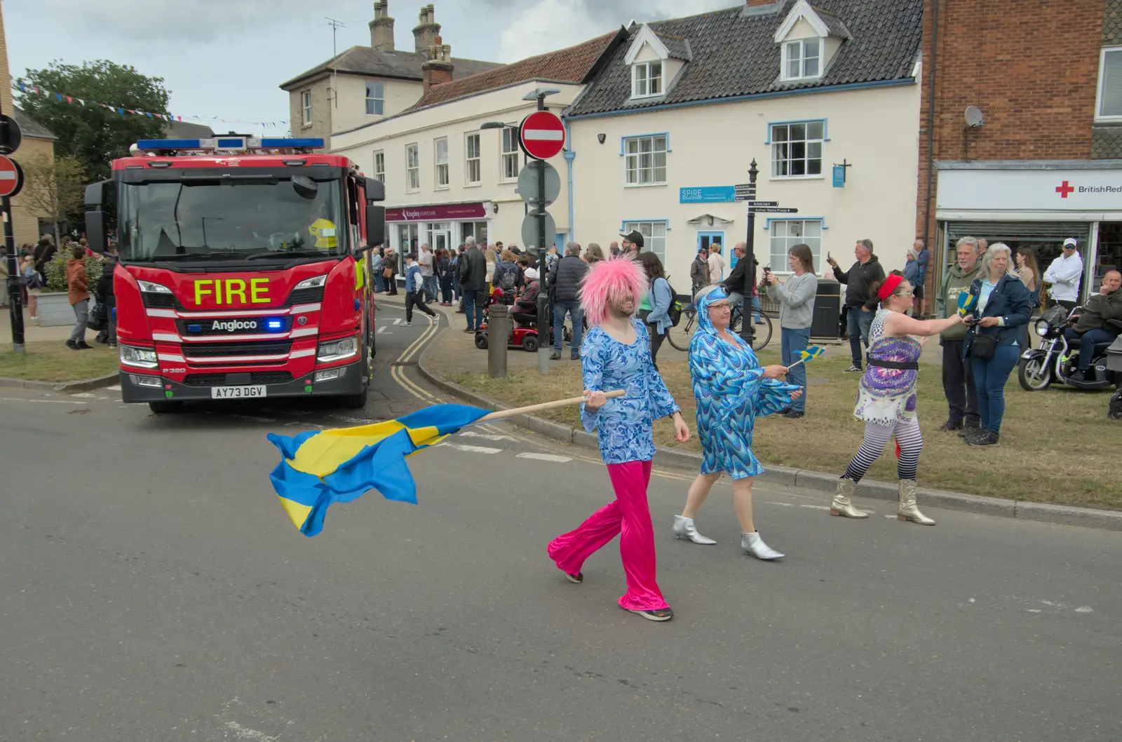 Cathal waves a Swedish flag around, from Palgrave Players do the Carnival, Diss, Norfolk - 8th June 2025