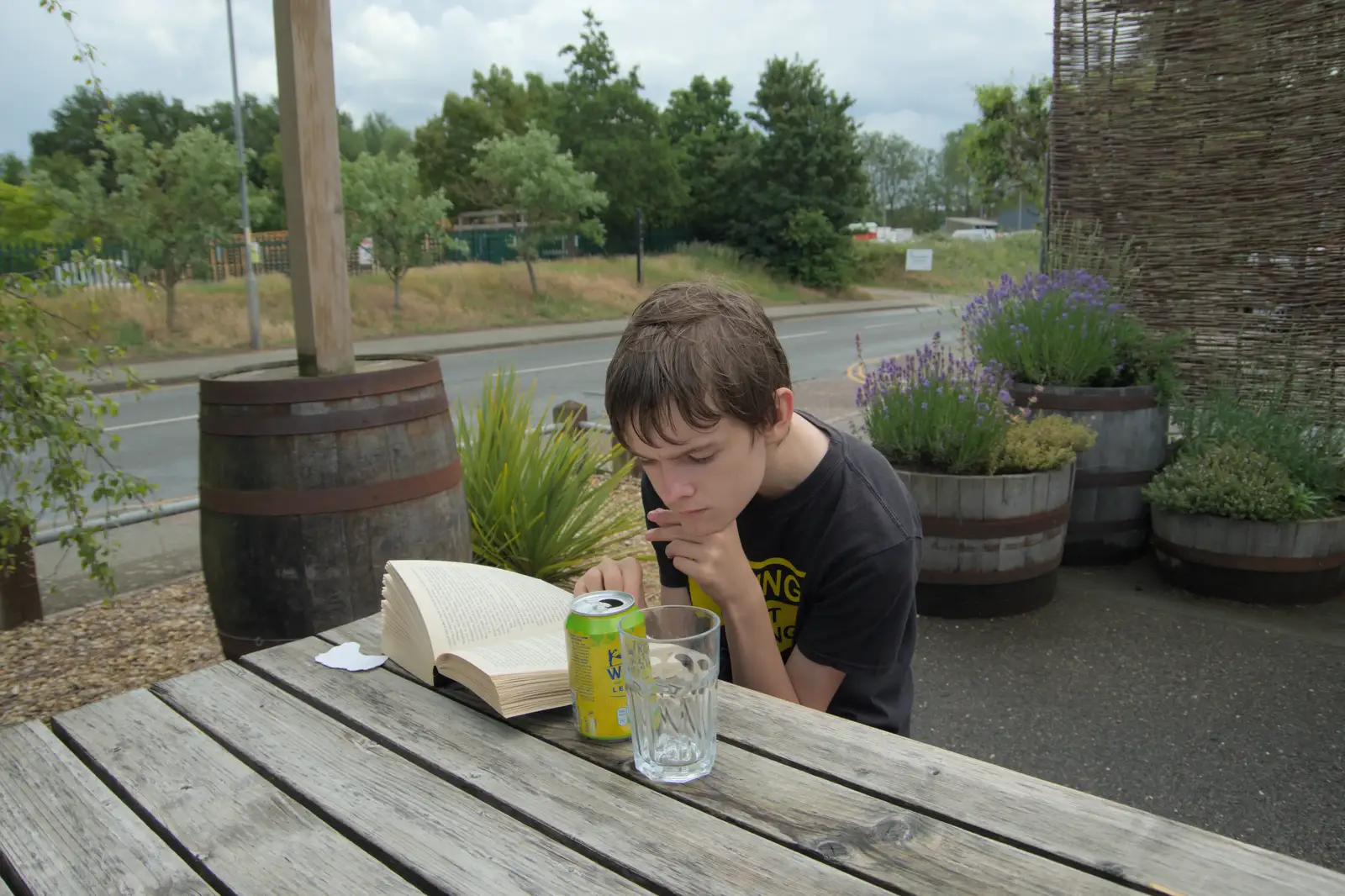 Harry reads a book at Ampersand Tap, from A Swarm of Bees, Eye, Suffolk - 16th June 2025