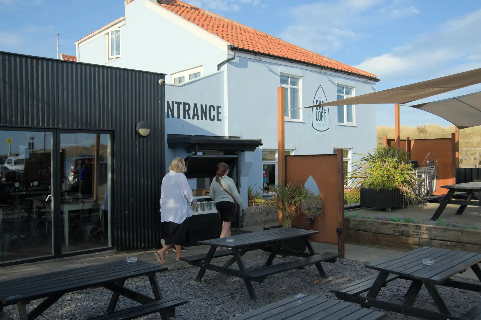 Mirka and Isobel walk into the Sail Loft, from Harry's Karate Kamp, Blackshore, Southwold - 5th July 2025