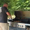 It's sausage time on the barbeque, The Brome and Oakley Fete, Brome Hall, Suffolk - 12th July 2025