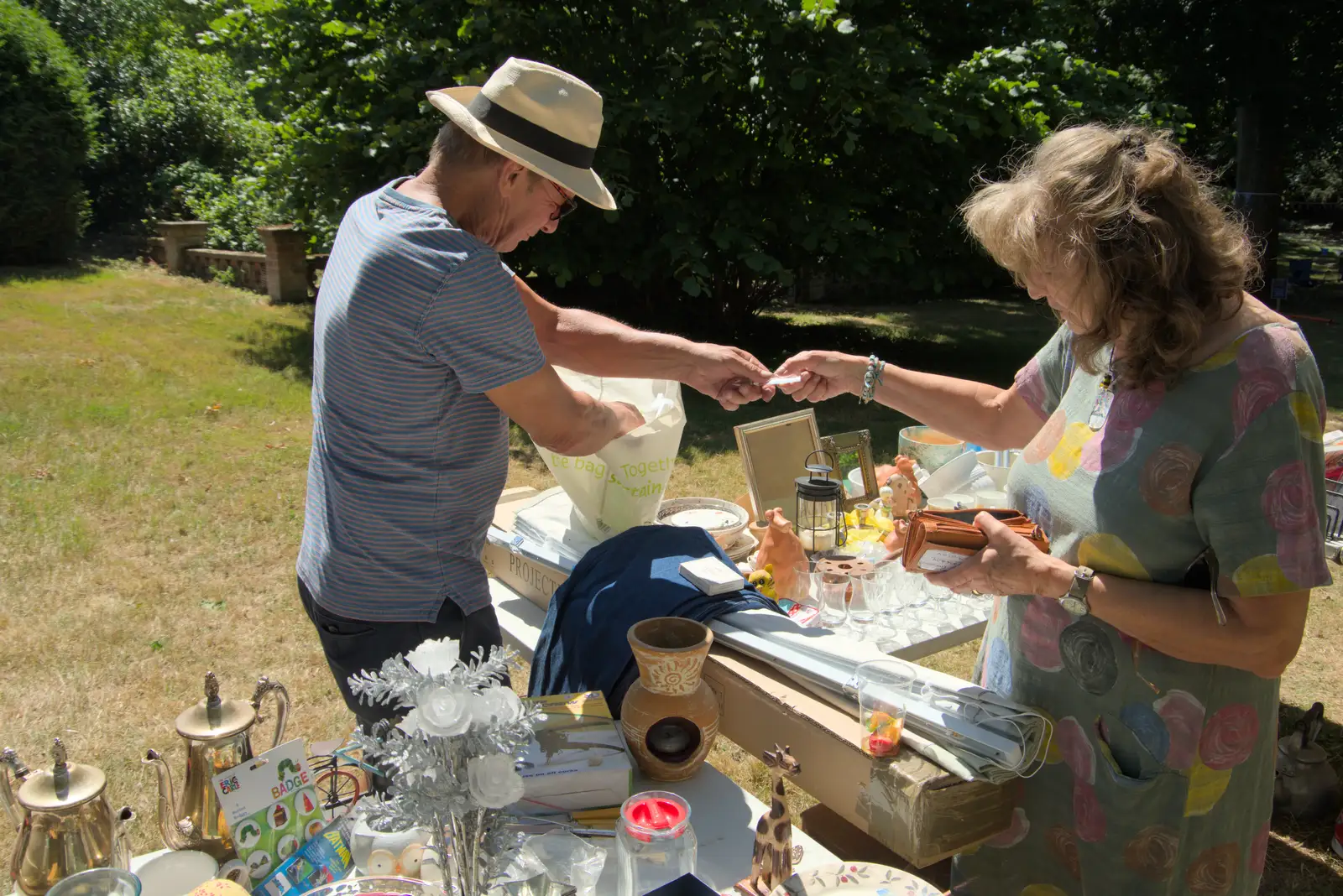 Tony sells something off his bric-a-brac stall, from The Brome and Oakley Fete, Brome Hall, Suffolk - 12th July 2025