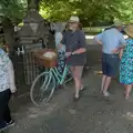Tim wheels a bicycle around, The Brome and Oakley Fete, Brome Hall, Suffolk - 12th July 2025