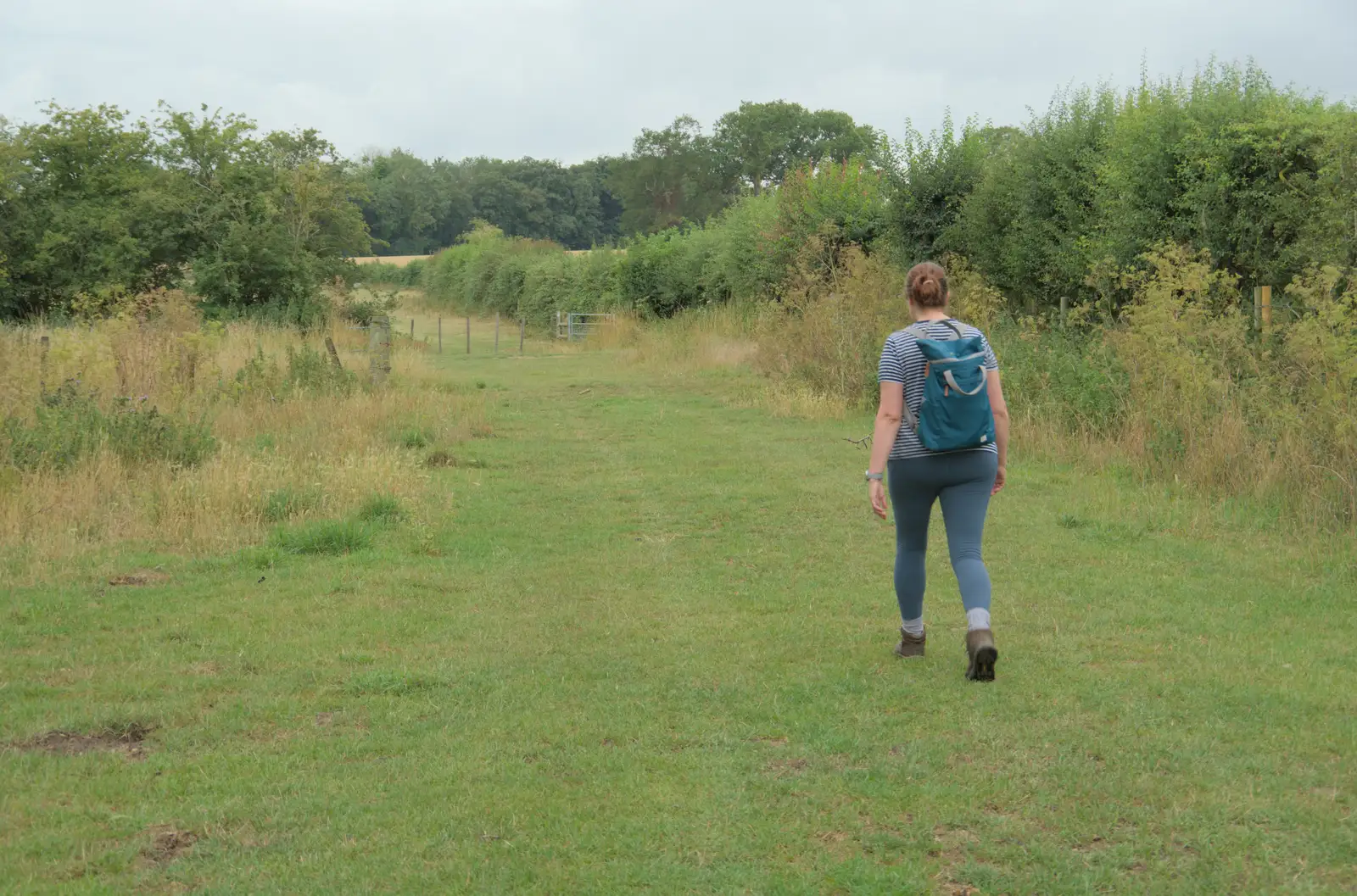 Isobel walks off along the Mid-Suffolk Path, from A Wet Walk to the Black Horse, Thorndon, Suffolk - 20th July 2025